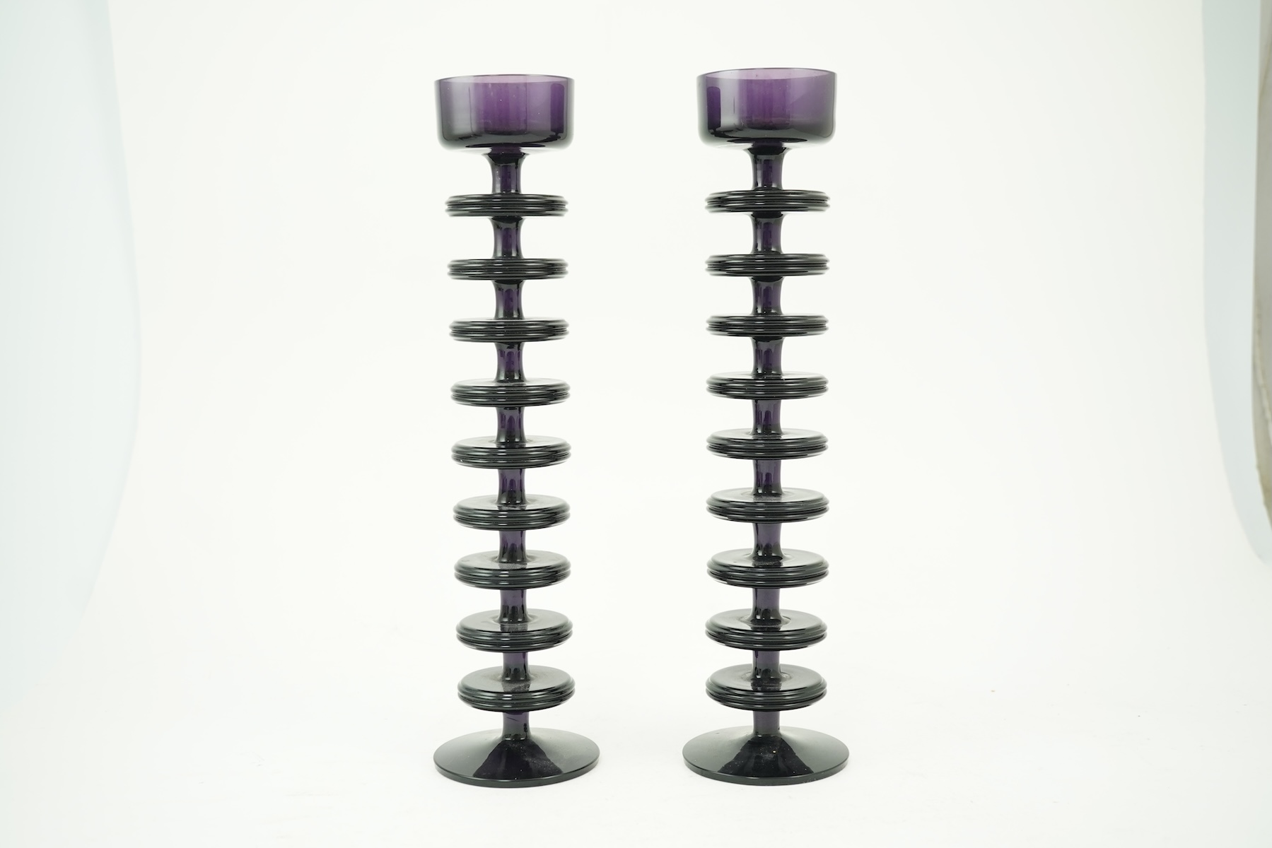 Ronald Stennett-Wilson (1915-2009) for Wedgwood: A pair of nine-ring 'Sheringham' amethyst glass candlesticks